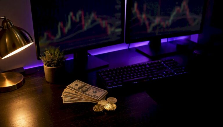 1786507393245_Home-trading-desk-featuring-charts-and-gold-bars Home trading desk featuring charts and gold bars