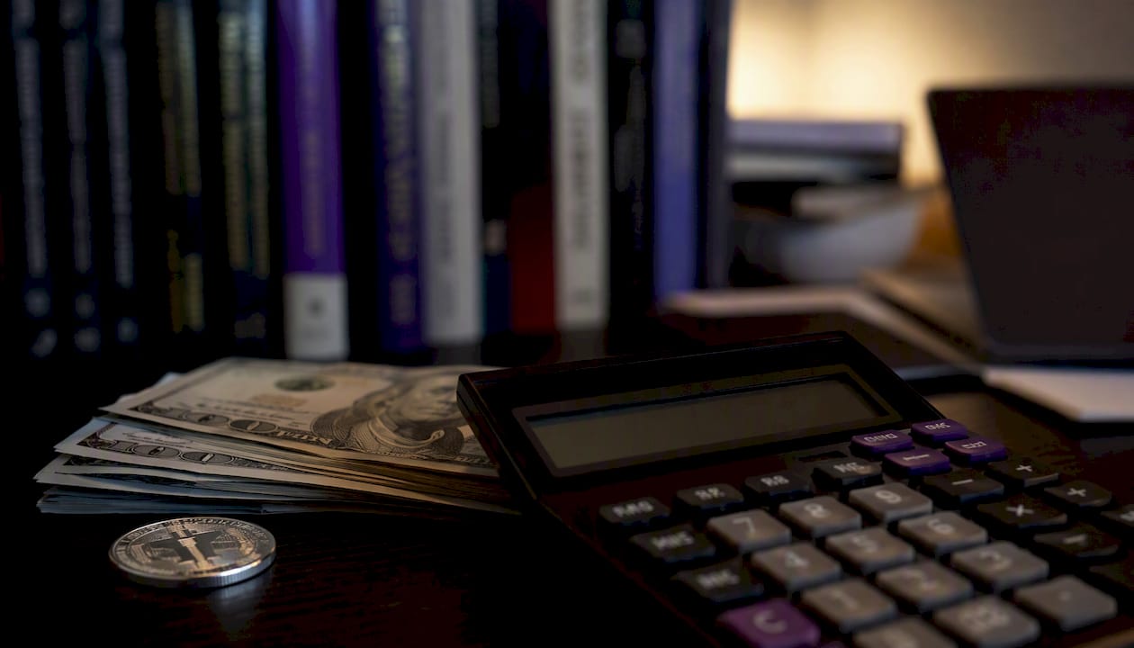 Trading desk with calculator and currency close-up